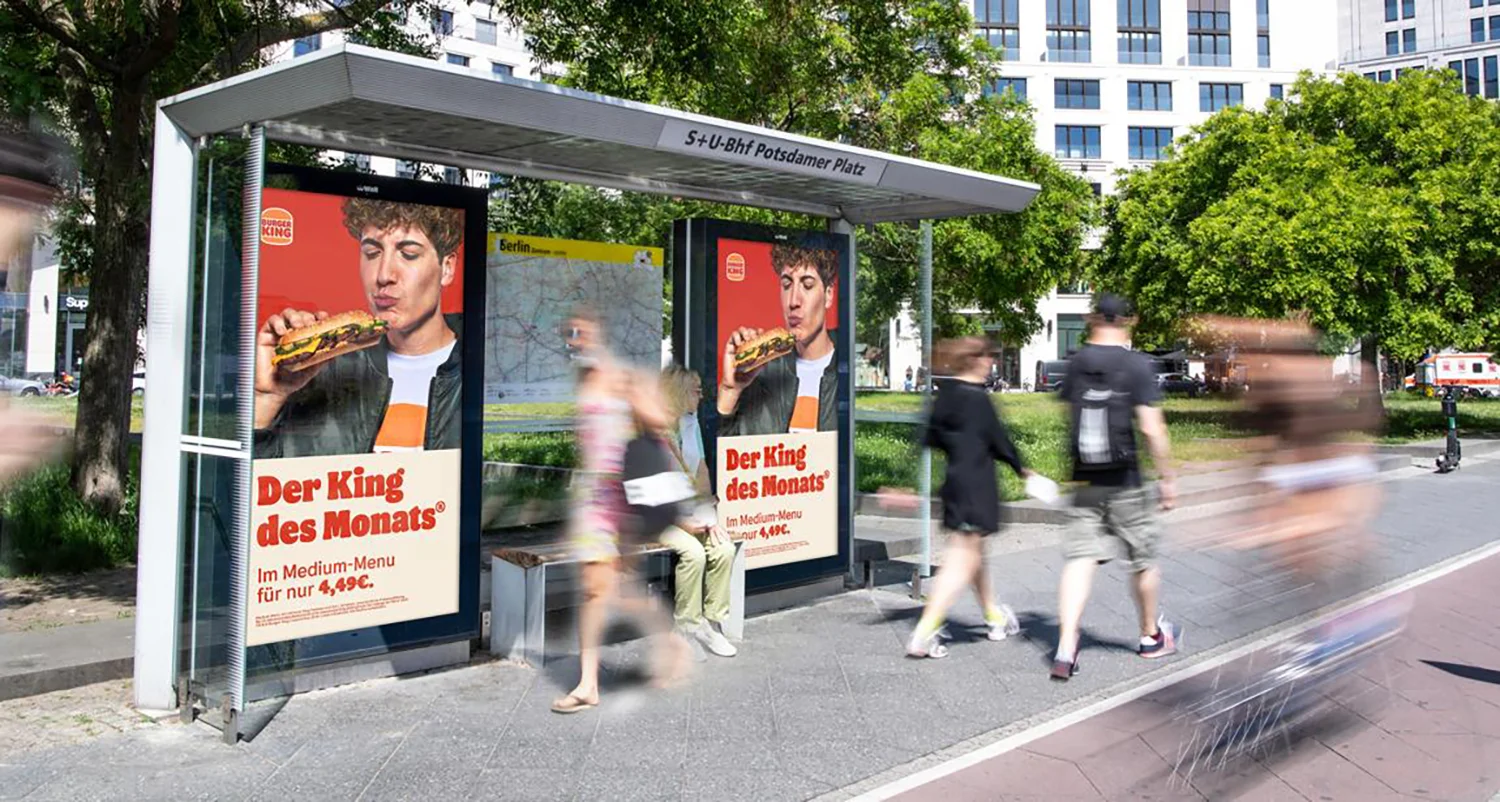 Zwei Digital City Light Poster an Bus-Wartehalle zeigen am Potsdamer Platz Werbung für eine Fast-Food-Kette